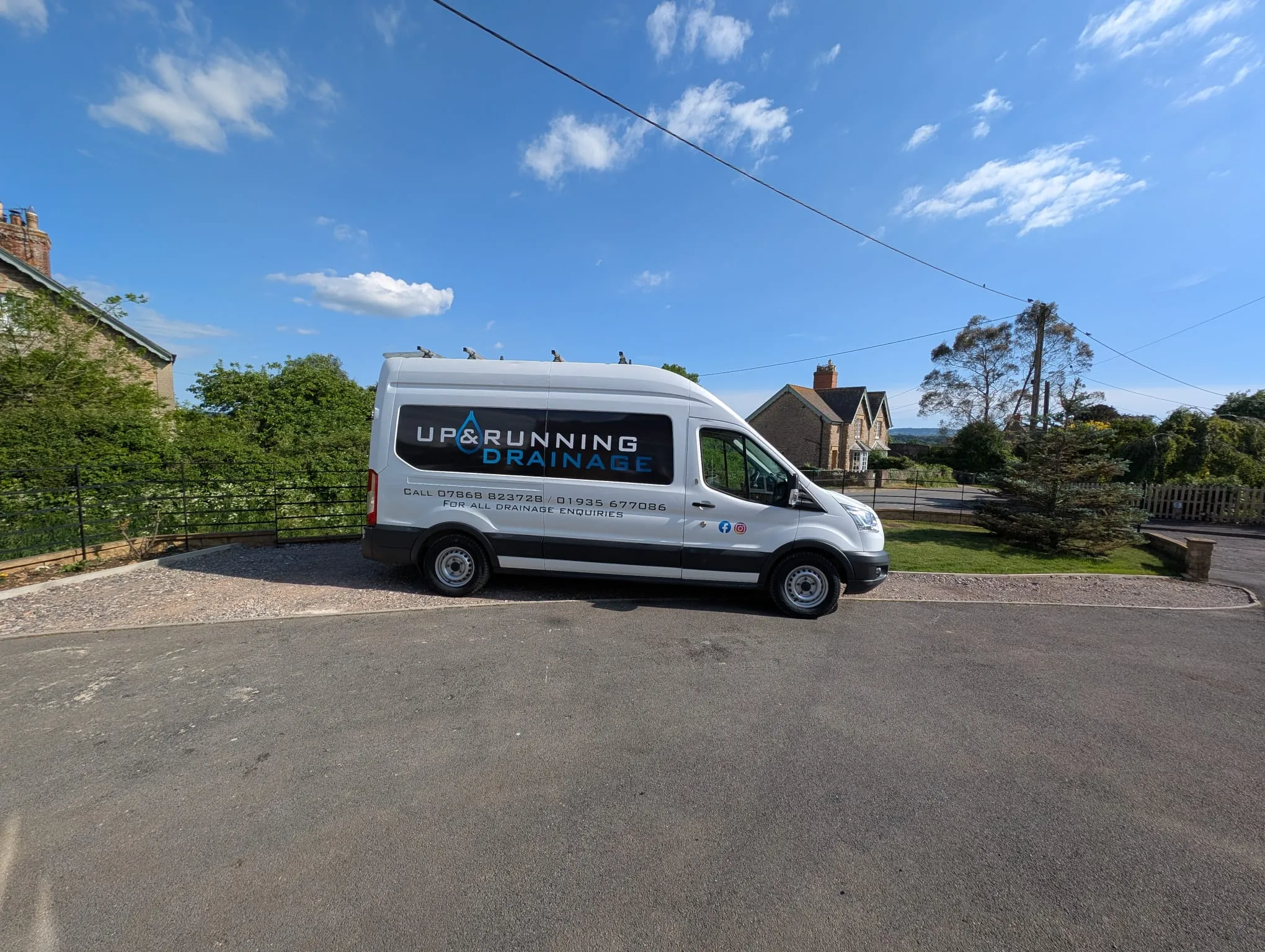 A white van parked on the side of a road.