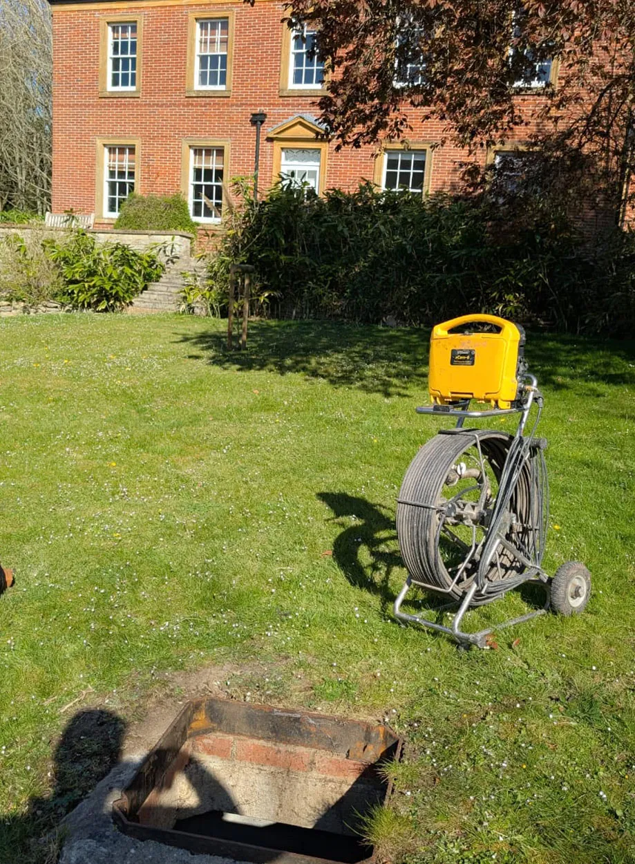 A bike parked next to a fire hydrant on a lush green field.