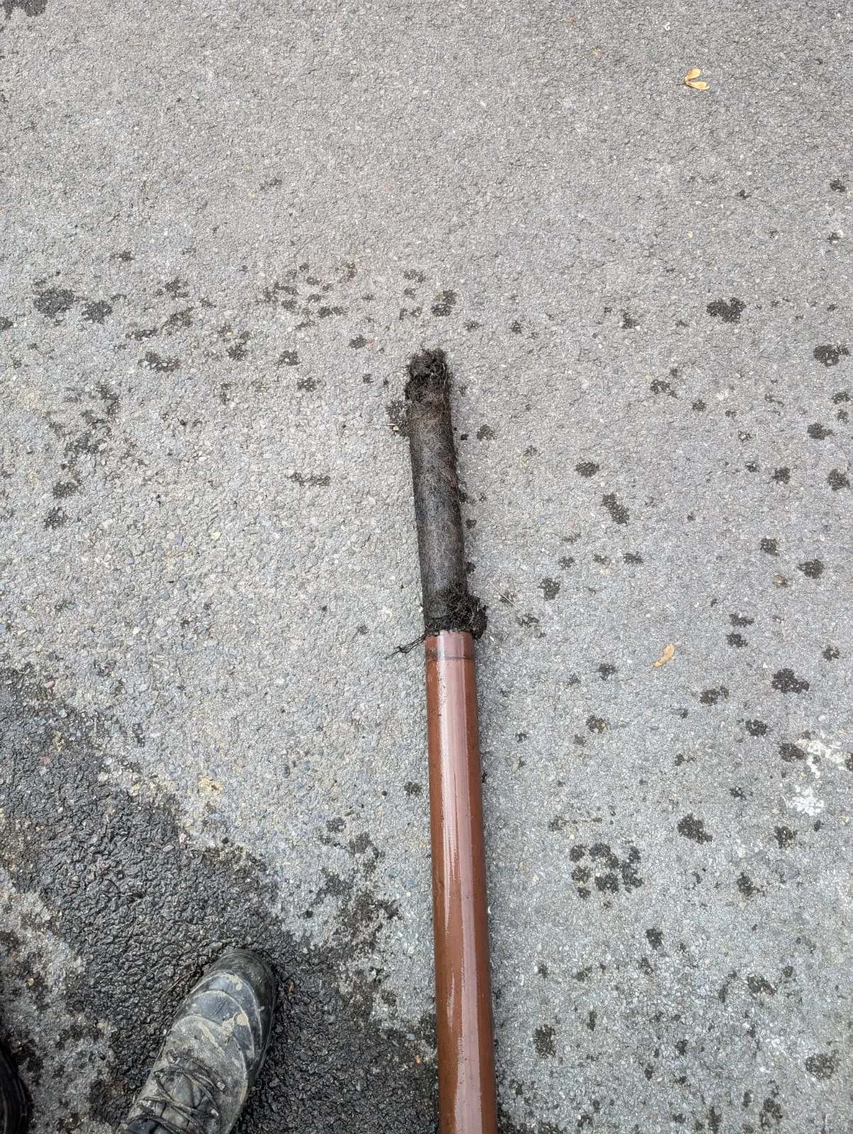A broken baseball bat laying on the ground.