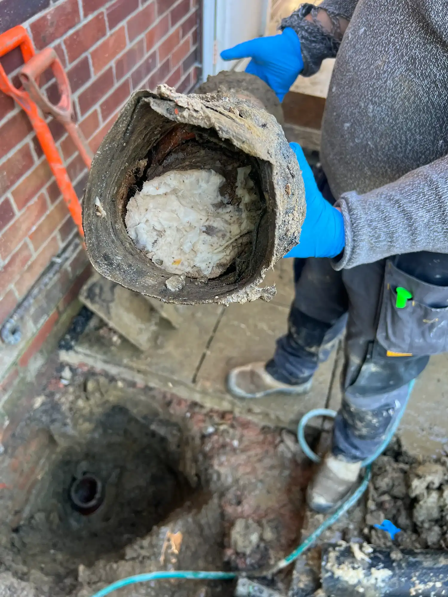 someone holding a pipe with a hole in it