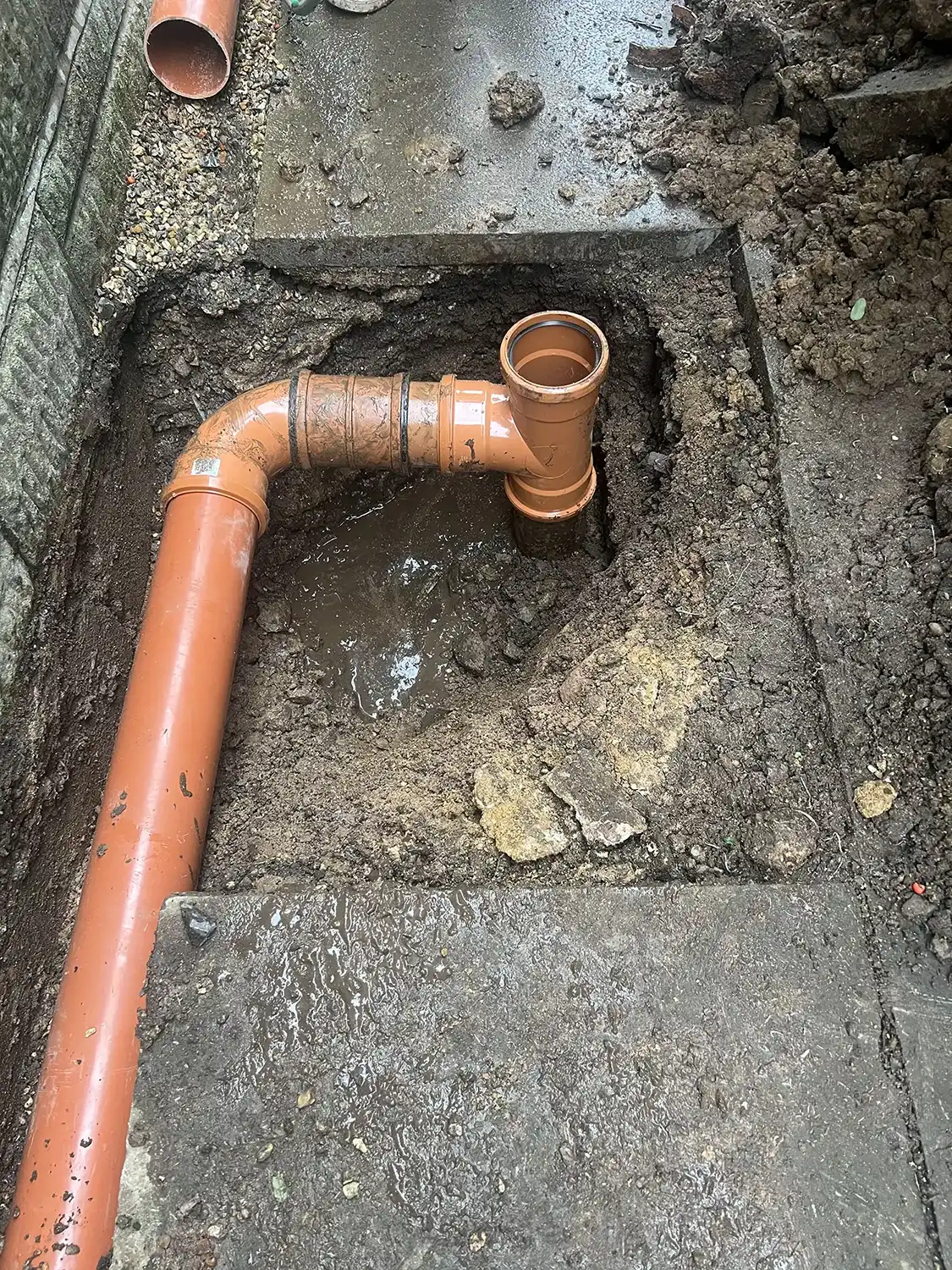 a pipe that is in the ground with a hole