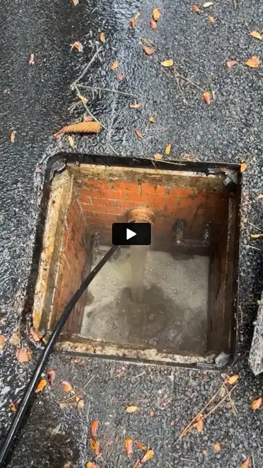 a close up of a sewer with a hose in it
